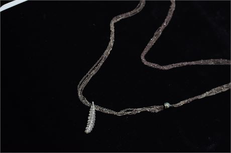 Multi-strand chain-link necklace with feather form pendant
