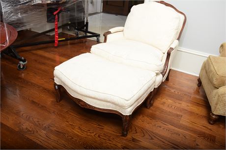 UPHOLSTERED ARMCHAIR AND OTTOMAN