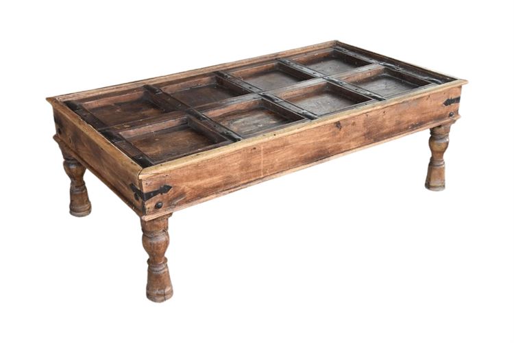 Antique Paneled Door with Iron Accents Turned into a Coffee Table